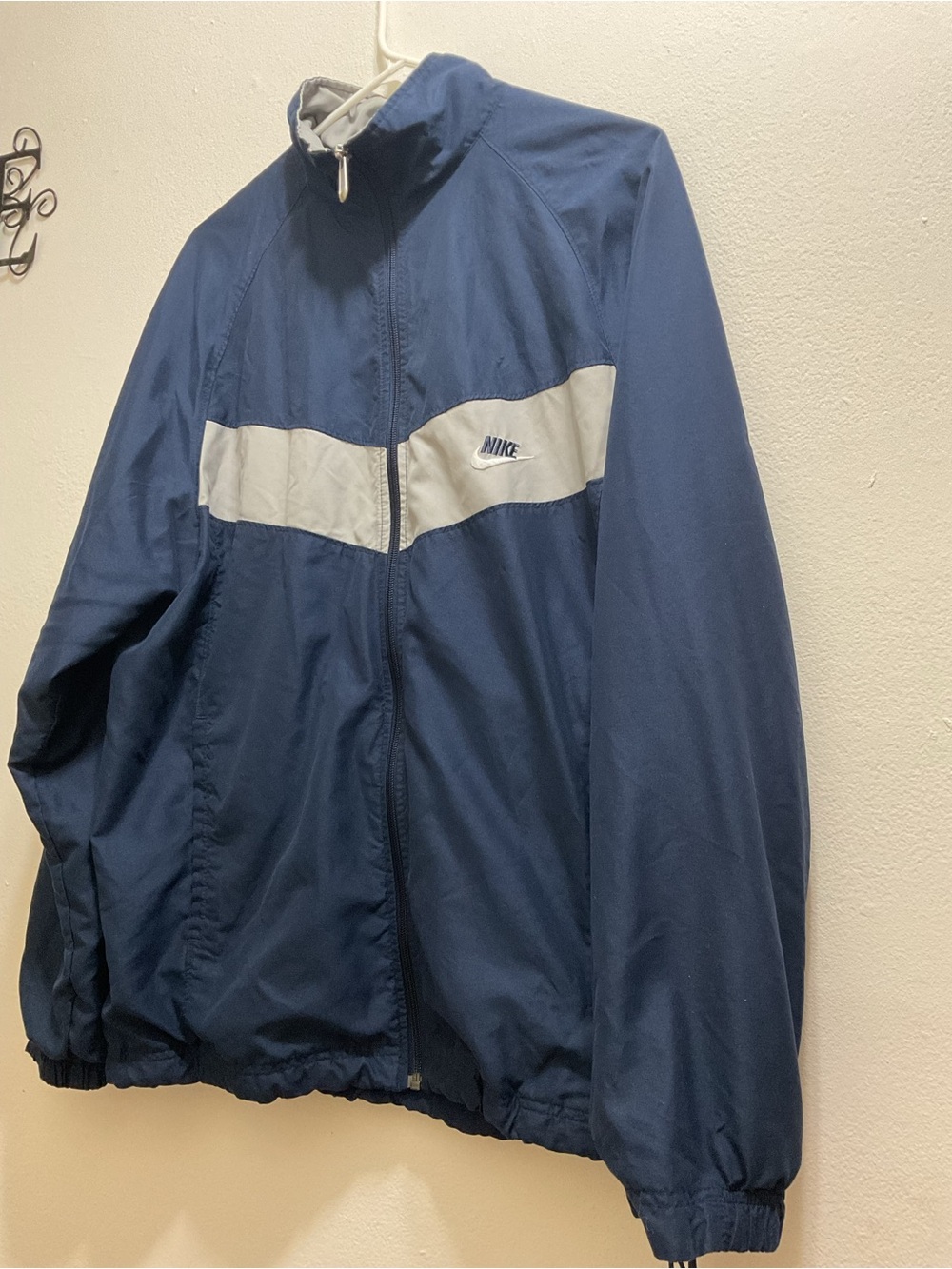 Vintage Nike Men’s Navy Blue Windbreaker with White Chest Stripe